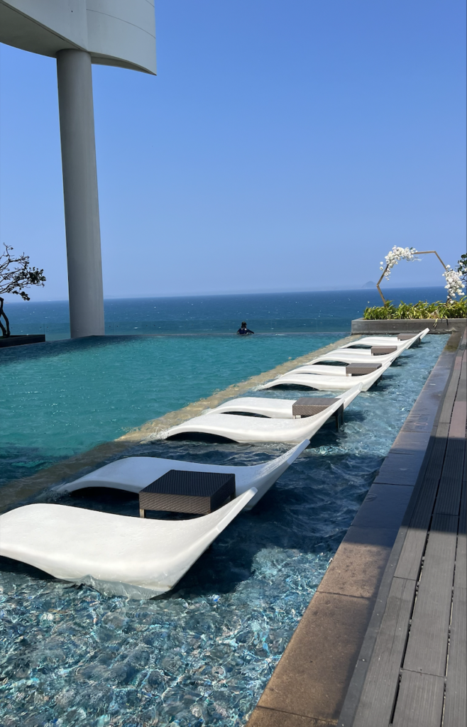 ocean view from the rooftop pool at the Sheraton Nha Trang hotel and spa, with an infinity pool and lounge chairs, perfect for laid back luxury
hidden gem destinations